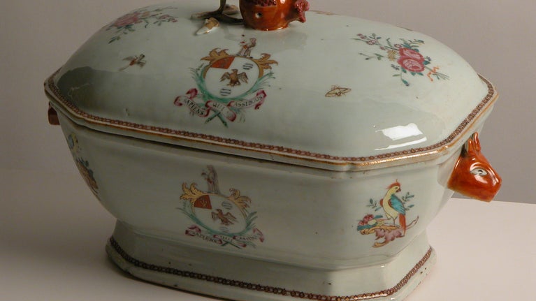 Tureen cover in famille rose enamels with the arms of Sykes of Basildon Park. Motif of two pink roses tied with a red ribbon surrounded by butterflies and birds. Edge of cover gilded.